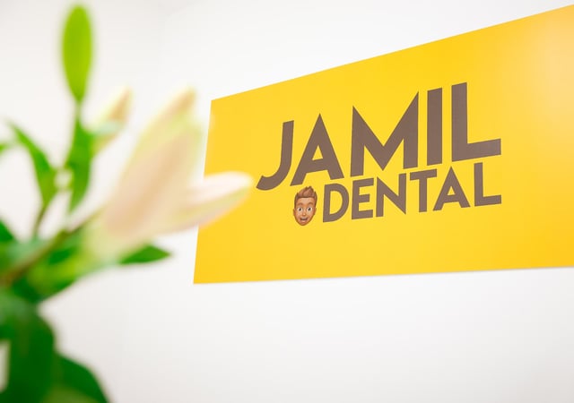 Jamil Dental wall sign reading Come in as a patient, leave as a smiler